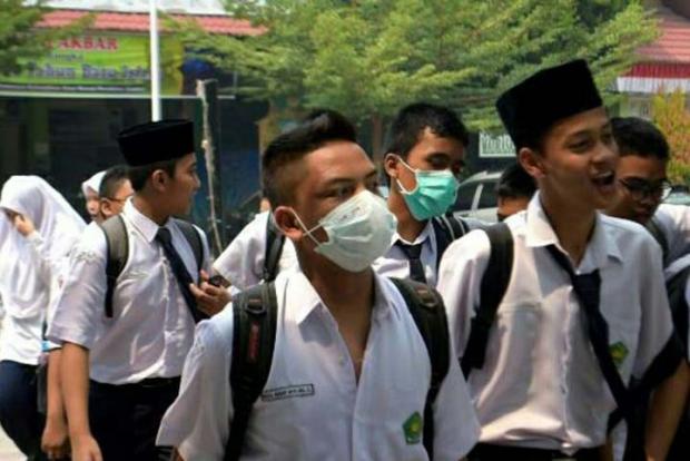 Dampak Kabut Asap Kebakaran Hutan di Riau; Warga Kena Demam hingga Siswa Sekolah Dipulangkan